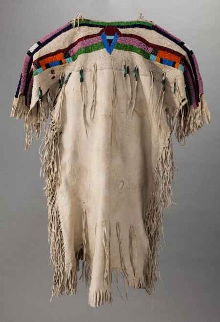 A PLATEAU GIRL'S BEADED HIDE DRESS c. 1910: A PLATEAU GIRL'S BEADED HIDE DRESSc. 1910with lanes of beadwork, stitched in numerous s