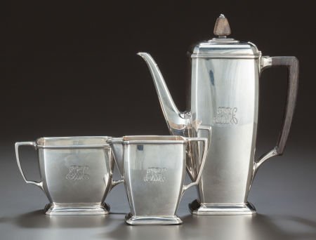 A THREE PIECE AMERICAN SILVER AND EBONIZED WOOD: A THREE PIECE AMERICAN SILVER AND EBONIZED WOOD COFFEE SERVICE, Tiffany & Co., New York,