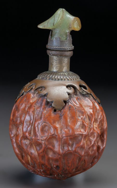 A CHINESE WALNUT SHELL, BRONZE AND JADE SNUFF BO: A CHINESE WALNUT SHELL, BRONZE AND JADE SNUFF BOTTLE 2-1/2 inches high (6.4 cm) The waln
