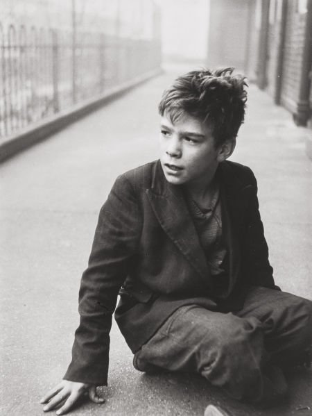 Roger Mayne (British, 1929-2014) Boy seated on s: Roger Mayne (British, 1929-2014)Boy seated on sidewalk, circa 1956Gelatin s