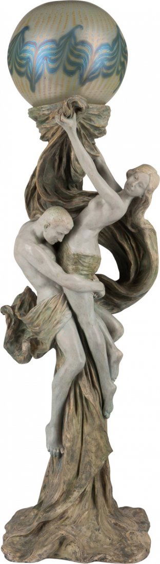 A French Art Nouveau Polychrome Pottery Figural: A French Art Nouveau Polychrome Pottery Figural Floor Lamp with Loetz Feather-Pulled Iridescent Glass