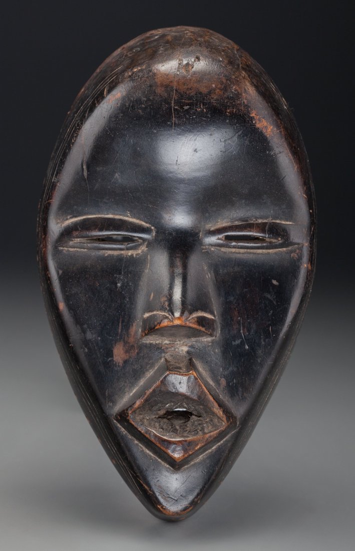 DAN, Liberia Mask Wood This Dan mask is of a type: DAN, Liberia Mask Wood This Dan mask is of a type called Deangle, used for the masquerade of the circumcision camp. Glossy black patina and delicate carving. Provenance: The Robert V. Be