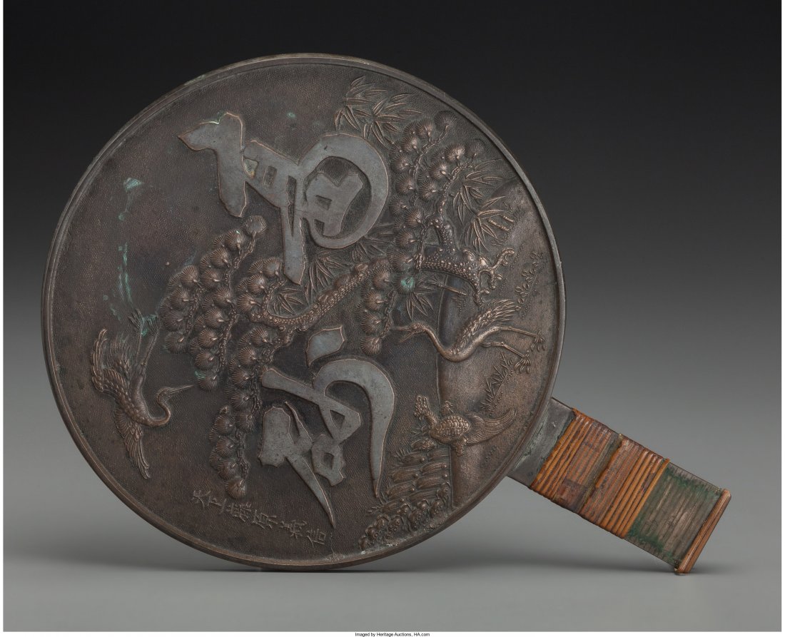 A Japanese Silvered Bronze Stork and Minogame Ha: A Japanese Silvered Bronze Stork and Minogame Hand Mirror</