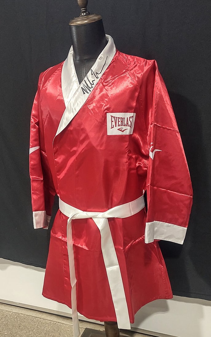 MIKE TYSON SIGNED DUAL AUTHENTICATED EVERLAST ROBE (PSA AND FITERMAN): Mike Tyson, born June 30, 1966, remains one of the most iconic figures in boxing history, known for his ferocious style and reign as the undisputed world heavyweight champion.Boxing Career and LegacyY
