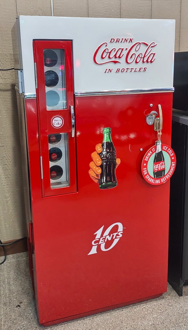 COCA COLA 10C- MACHINE TOTALLY RESTORED: The 10-cent (10¢) pricing era typically represents machines from the late 1940s through the 1950s. Bright red exterior with the Coca-Cola logo at the top A glass front displaying bottled drinks insid