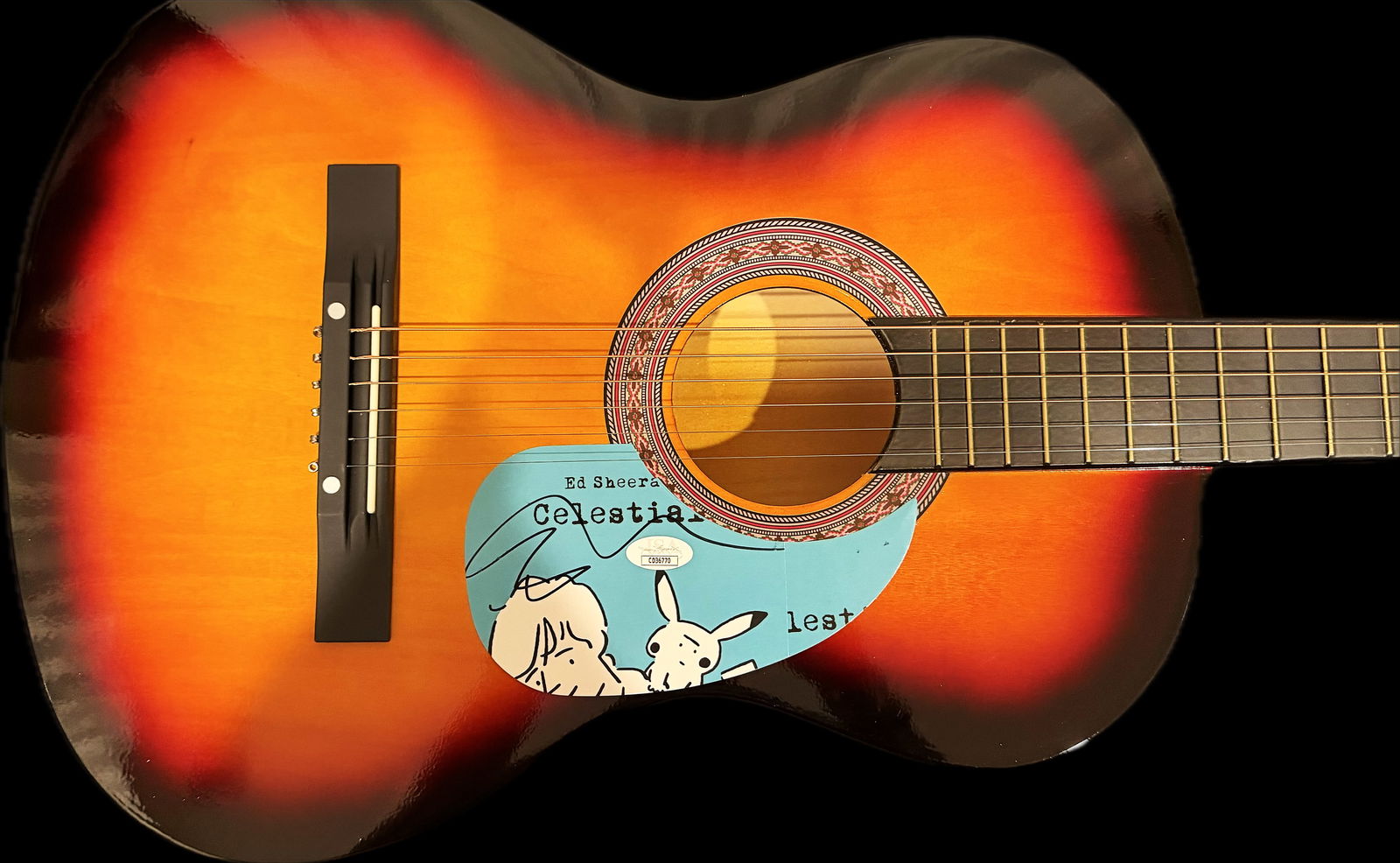 ED SHEERAN GUITAR WITH SIGNED CUSTOM INSERT PICKGUARD AUTHENTICATED (JSA): Ed Sheeran: The Singer-Songwriter IconEd Sheeran is one of the world's best-selling music artists, known for his storytelling and master of the loop pedal. Signature Guitars: He famously plays