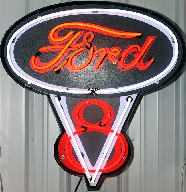 FORD V8 NEON: BIG NEON SIGNS IN STEEL CANS 27 x 28 x 6 Ford V8 neon sign. The top part is an oval with "Ford" written in red/orange neon script, outlined in white neon. Below it is a stylized "V8" in a similar