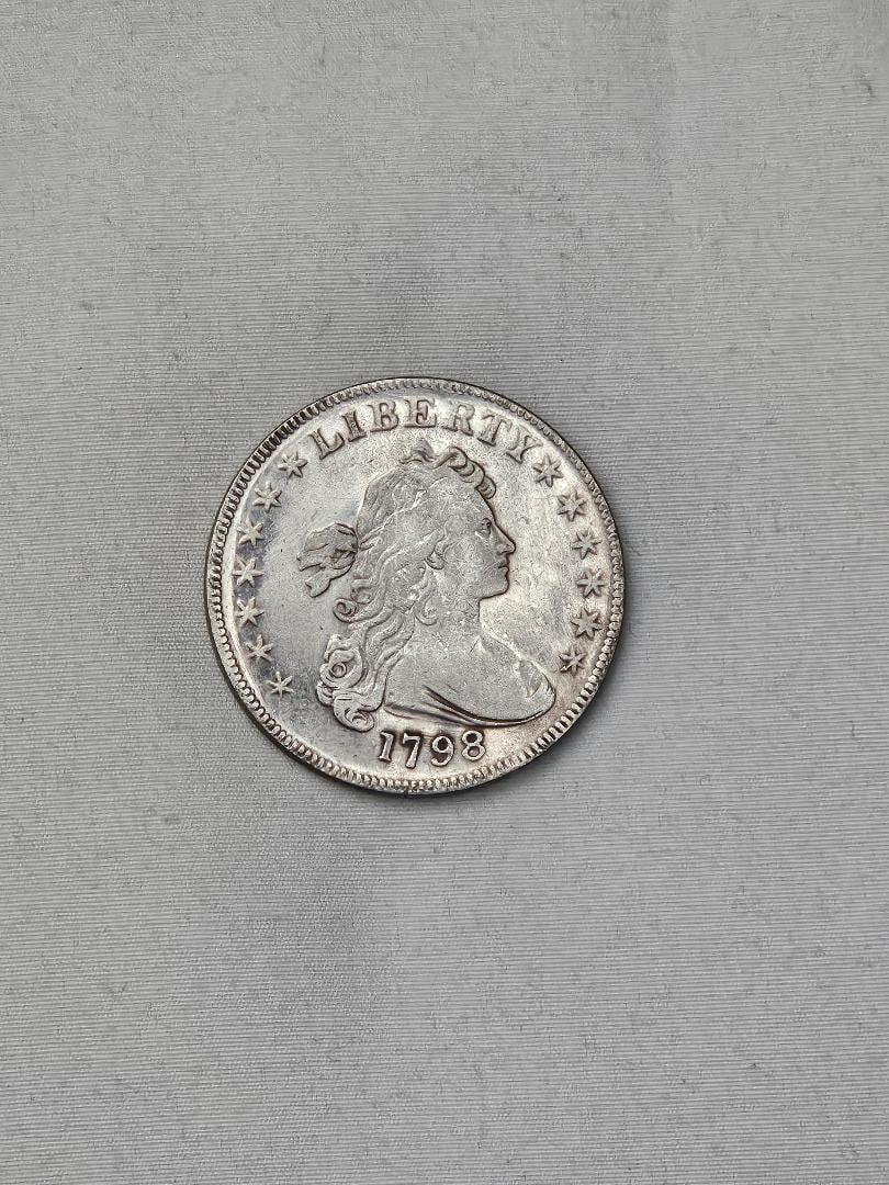1798 UNITED STATES BUST DOLLAR, SMALL EAGLLE: You are looking at our country's earliest money. The first Silver Dollar ever minted was in 1794, this design is the second and has the small eagle on the back, a sign of our vintage money from when
