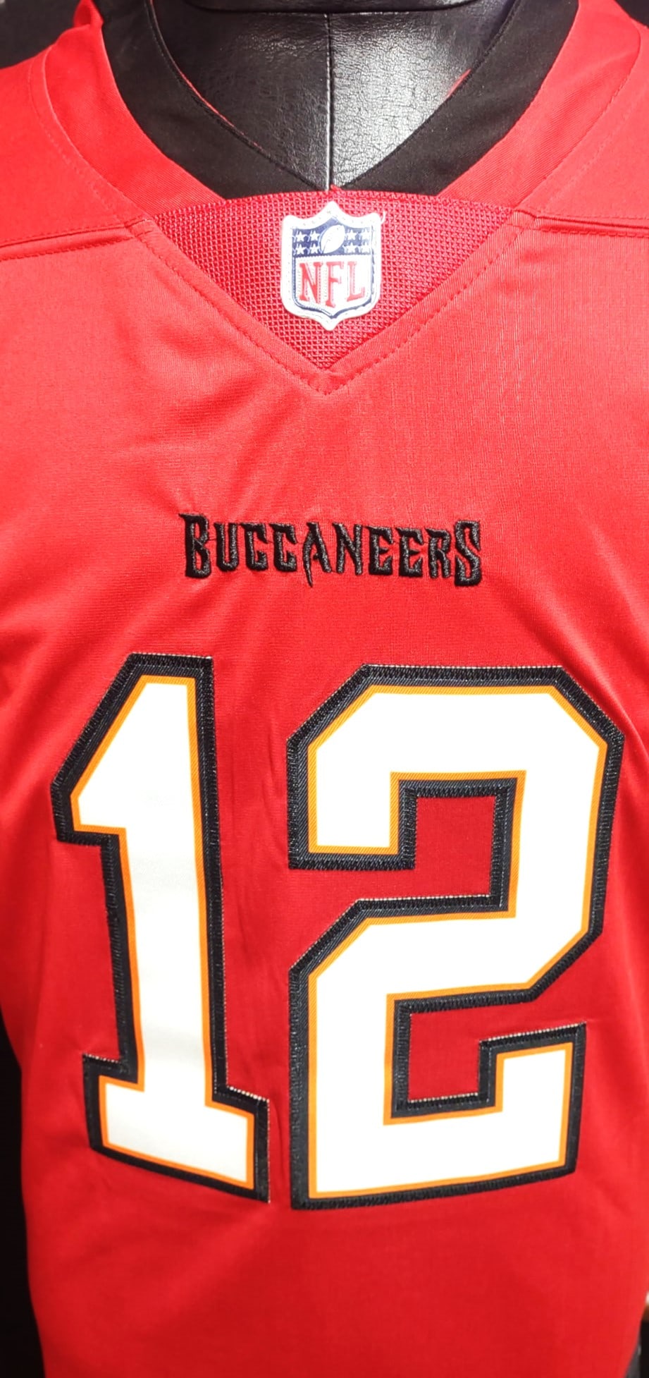 TOM BRADY SIGNED AUTHENTICATED TAMPA BAY JERSEY: Offered is the Red Tampa Bay Buccaneers Jersey with the number 12, which was Brady's number during his time with the team. The signature is consistent with his known autograph, a flowing cursive