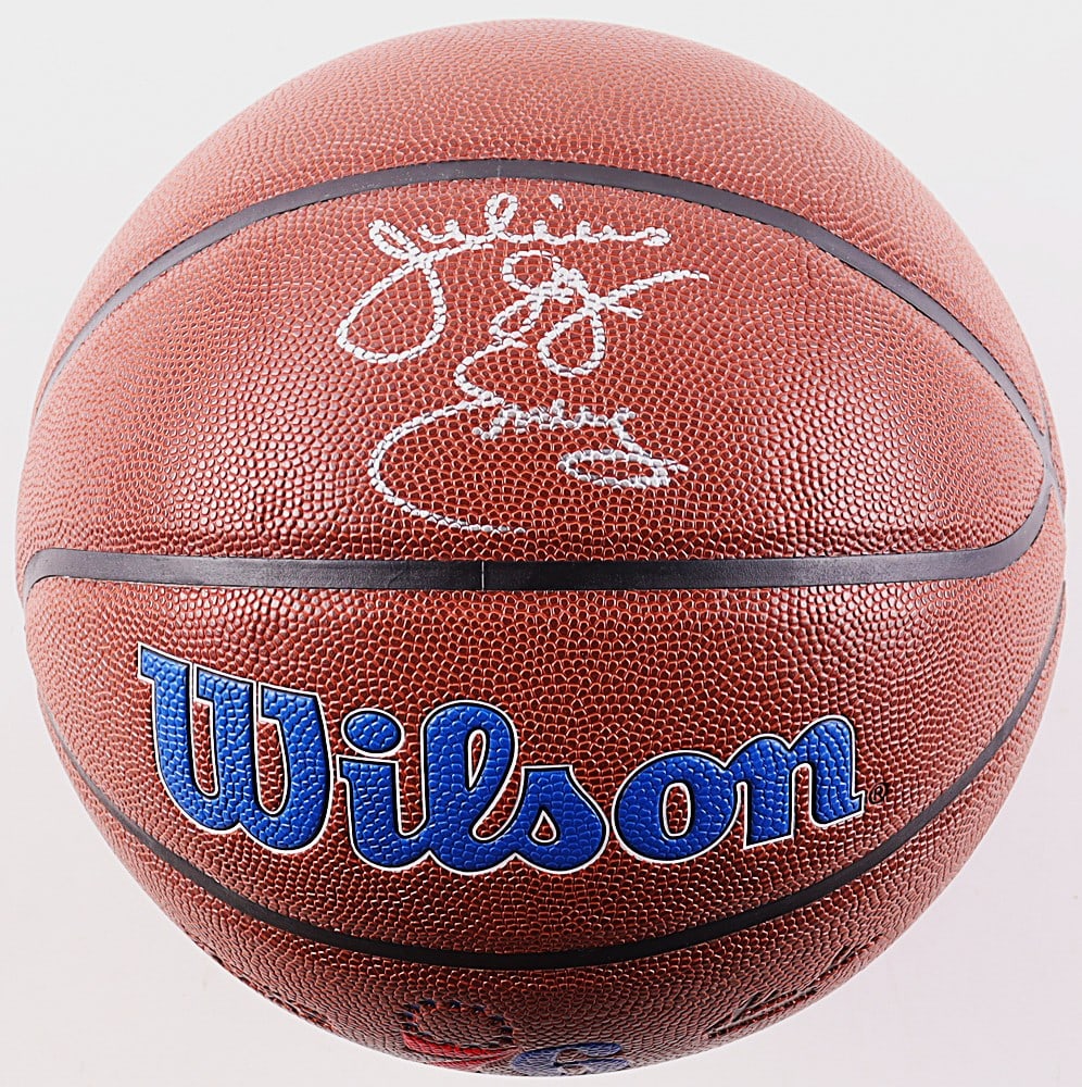 DR J JULIUS IRVING SIGNED BASKETBALL-PSA: Official-style Wilson NBA basketball featuring Philadelphia 76ers team graphics and multiple signatures executed in silver marker. The basketball displays prominently with the classic 76ers red,