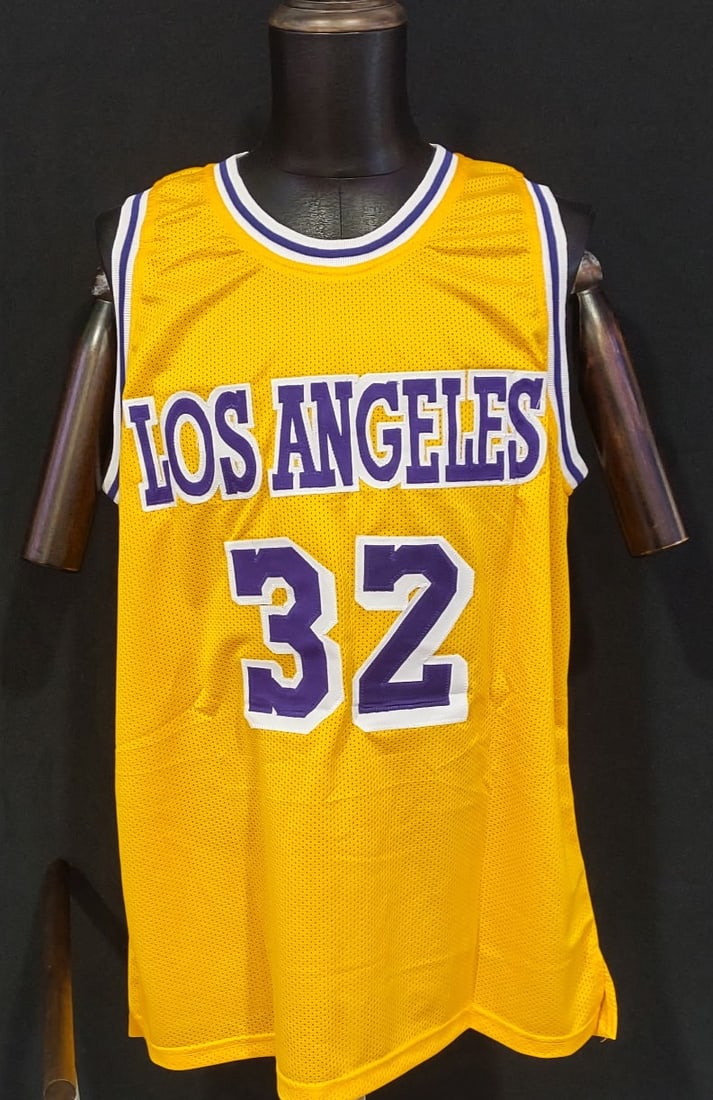 MAGIC JOHNSON SIGNED LOS ANGELES LAKERS #32 JERSEY — BECKETT WITNESS AUTHENTICATED: MAGIC JOHNSON SIGNED LOS ANGELES LAKERS #32 JERSEY — BECKETT AUTHENTICATED Outstanding Los Angeles Lakers gold basketball jersey featuring “JOHNSON” across the back with the iconic #32,