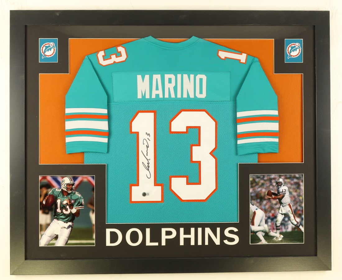 DAN MARINO SIGNED BECKETT AUTHENTICATED CUSTOM FRAMED JERSEY DISPLAY: DAN MARINO SIGNED BECKETT AUTHENTICATED CUSTOM FRAMED JERSEY DISPLAY Dan Marino is widely regarded as one of the greatest quarterbacks in NFL history. He played his entire 17-year NFL career