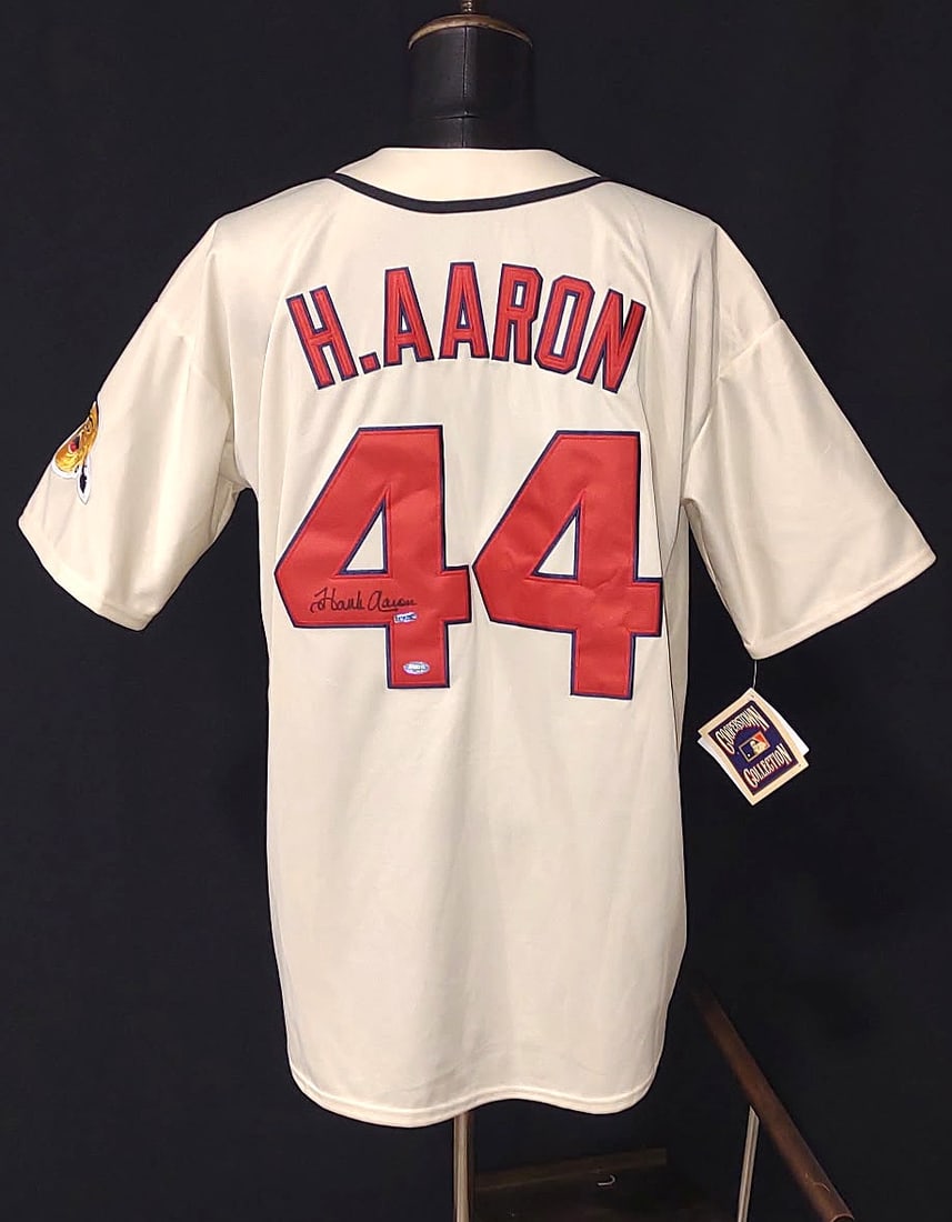 HANK AARON JERSEY FROM THE "HOME RUN KING" SIGNED AUTHENTICATED: HANK AARON SIGNED FORENSICALLY AUTHENTICATED BRAVES JERSEY The Jersey features the name "H. AARON" on the back above the number "44." This is a clear reference to Henry "Hank" Aaron, a Hall of Fame ou