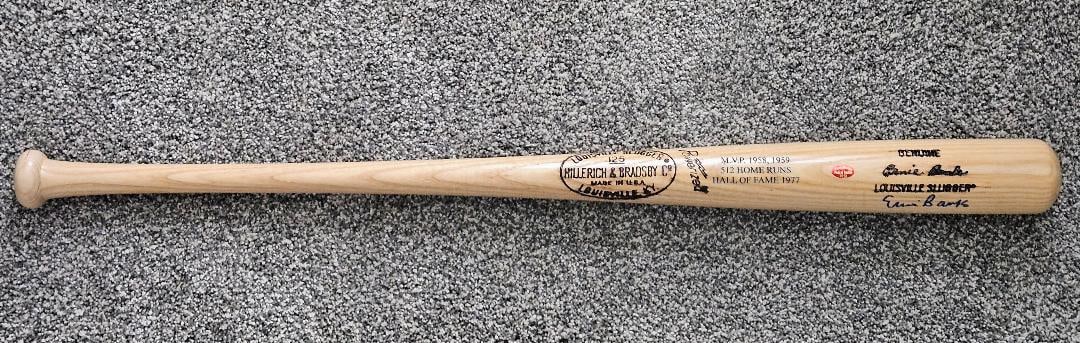 ERNIE BANKS JSA SIGNED COMMEMORATIVE LOUISVILLE SLUGGER BAT: Fantastic commemorative bat signed by Hall of Famer and Mr Cub Ernie Banks. The bat is a pro model S2 stamped on the handle. It is 34.5 inches long and weighs 34 ounces. The bat is specially stamped