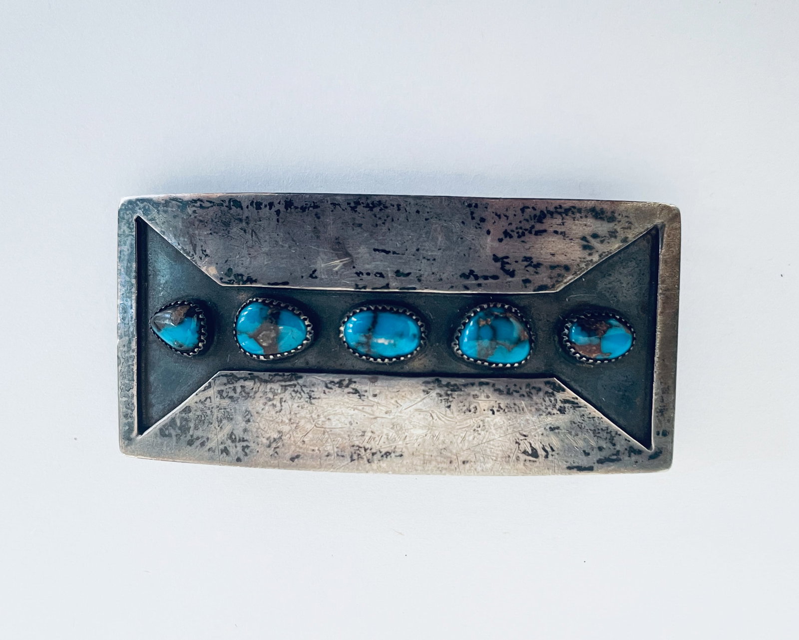 Old Pawn Bisbee Turquoise Belt Buckle: Vintage old pawnNavajo belt buckle hand made from silver with (5) authentic Bisbee, AZ turquoise cobachons. Measures 1.125 x 2.5 in. Weighs 27.65 grams