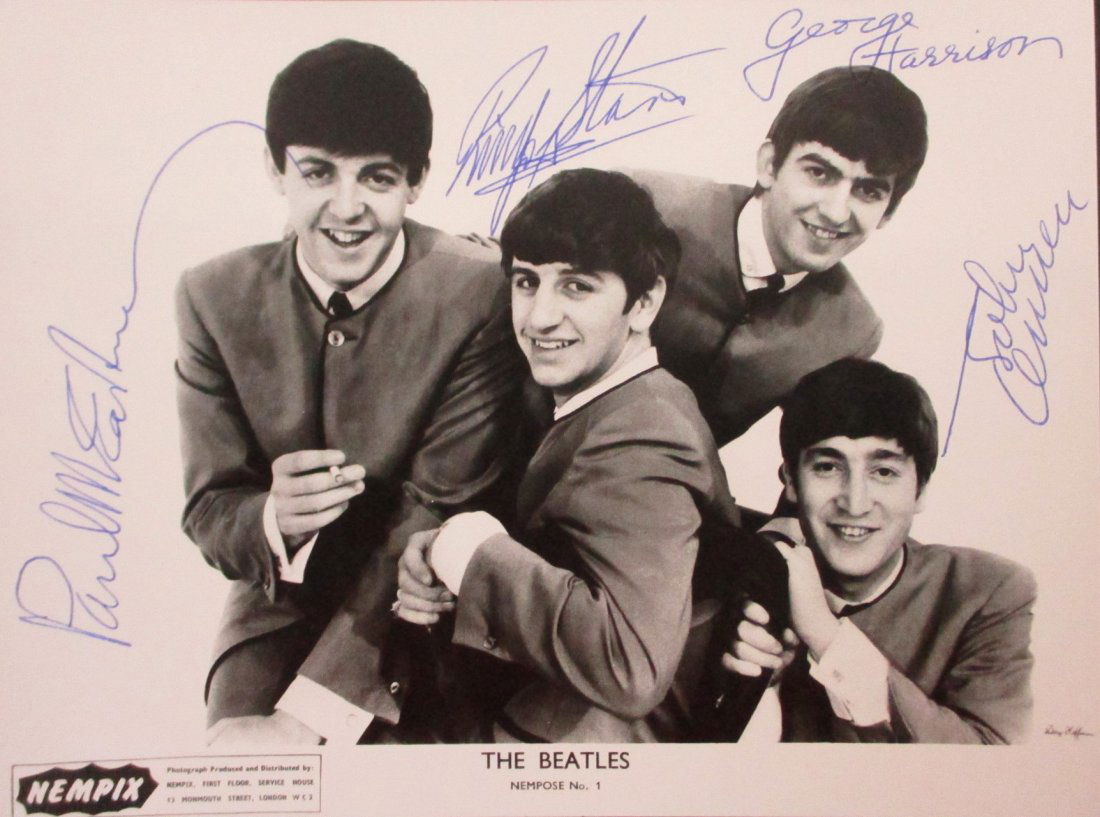 Beatles Signed NEMPOSE No 1 photo: This NEMS Enterprises promotional photo, titled "NEMPOSE No 1," features the legendary British rock band The Beatles during their early years of fame. The captivating black-and-white image showcases J