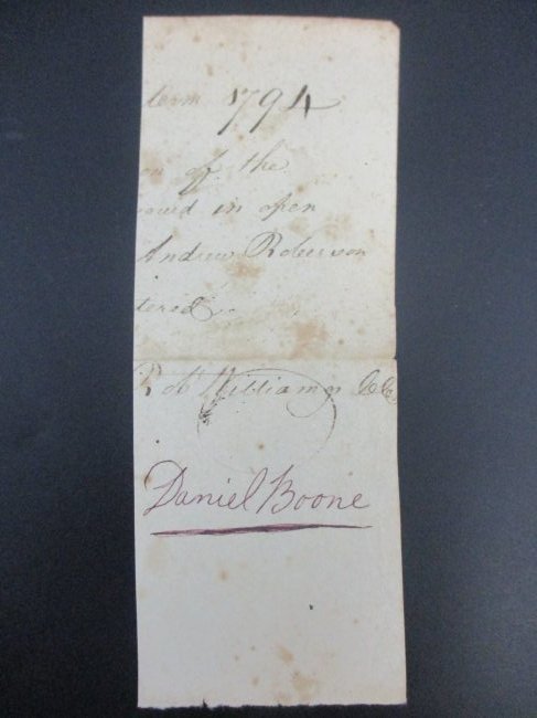 Daniel Boone's Authentic Signed Document Fragment Historical Relic: This remarkable artifact measures 6 1/2 x 2 1/2 and bears the unmistakable signature of the legendary frontiersman, Daniel Boone. Preserved through time, this partial document offers a tantalizing gli