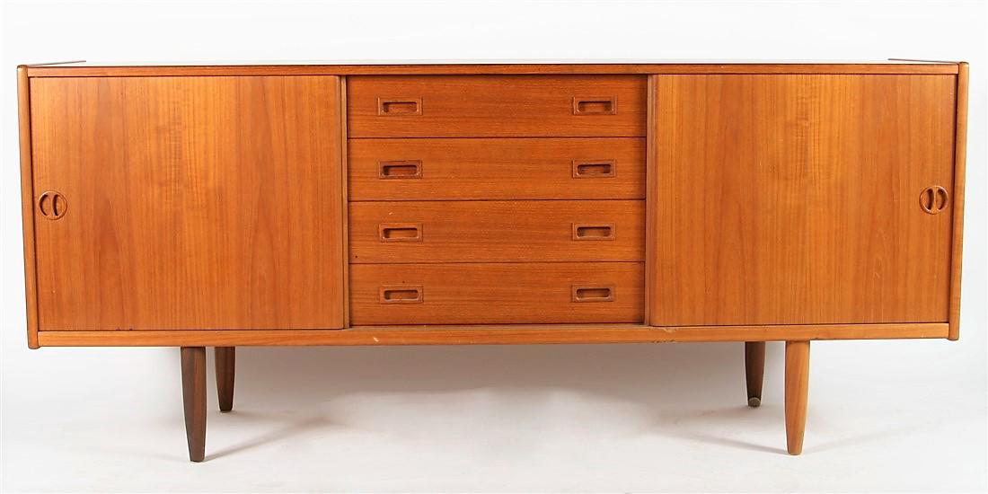 Mid-Century Modern Walnut Credenza: Height: 30 1/2", Length: 71", Width: 18 1/2". Credenza features four center drawers with rectangular pulls, one with sliding half drawer, as well as two sliding doors with circular pulls which reveal 