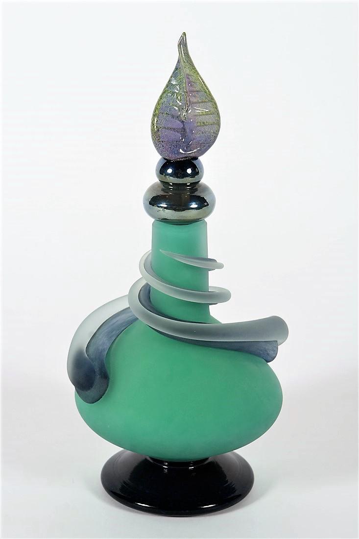 Eric Bladholm, Art Glass Bottle with Leaf Stopper: Eric Bladholm (American). Hand blown glass. 1995. Edition: 12/95. Height: 12 3/4" (approx.). Height (without stopper): 7 3/4" (approx.). Diameter of base: 4 1/4" (approx.). Bottle is predominately a j