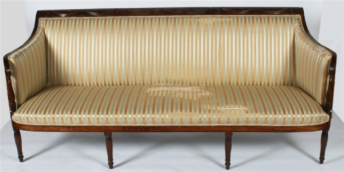 Early 19th C. Duncan Phyfe Period Mahogany Sofa: Mahogany and upholstery. American, c. 1800. Height: 35", Length: 80 1/4", Depth: 32". Seat Height: 15", Seat Depth: 21". Curved arm sofa features a carved back rail with swag, wheat, and tassel motifs