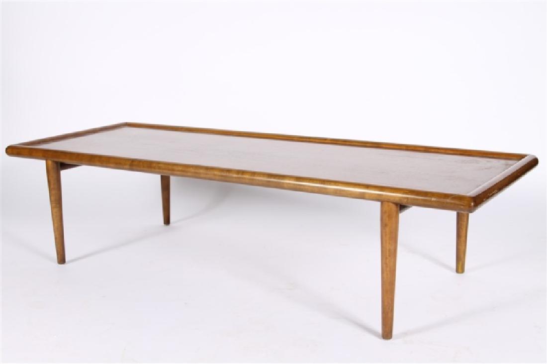 T.H. Robsjohn-Gibbings for Widdicomb, Coffee Table: T.H. Robsjohn-Gibbings (British, 1905-1976). Walnut. c. 1950's. Distributed by Widdicomb (USA, est. 1858). Height: 14 1/4", Length: 58", Depth: 22". Rectangular coffee table features a raised edge to 