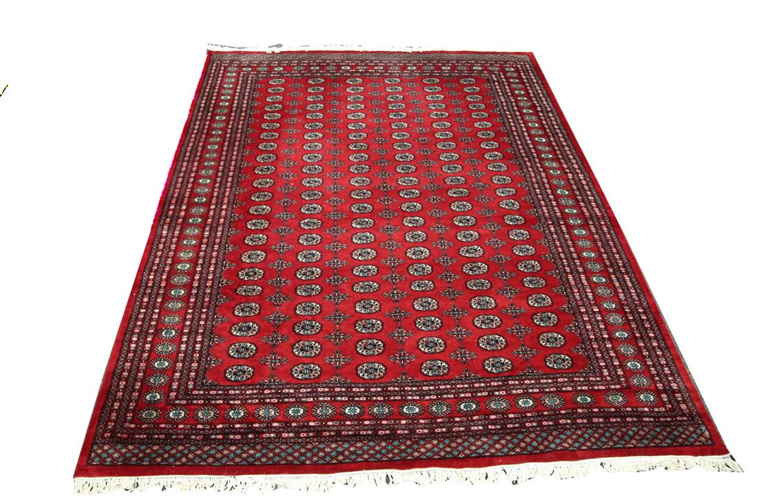 Bokhara Rug (Pakistan, c. Late 20th Century): Wool. Pakistan, c. late 20th C. 8' X 11'. Pakistani Bokhara rug with circle motif.