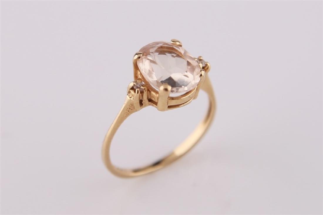 14KP Yellow Gold Ring with Morganite: 14kt yellow gold ring with morganite center stone. Two small diamonds approx. .02 cts. Marked within band "14 KP". Size: 5 1/4. Weight: 2.4 g.