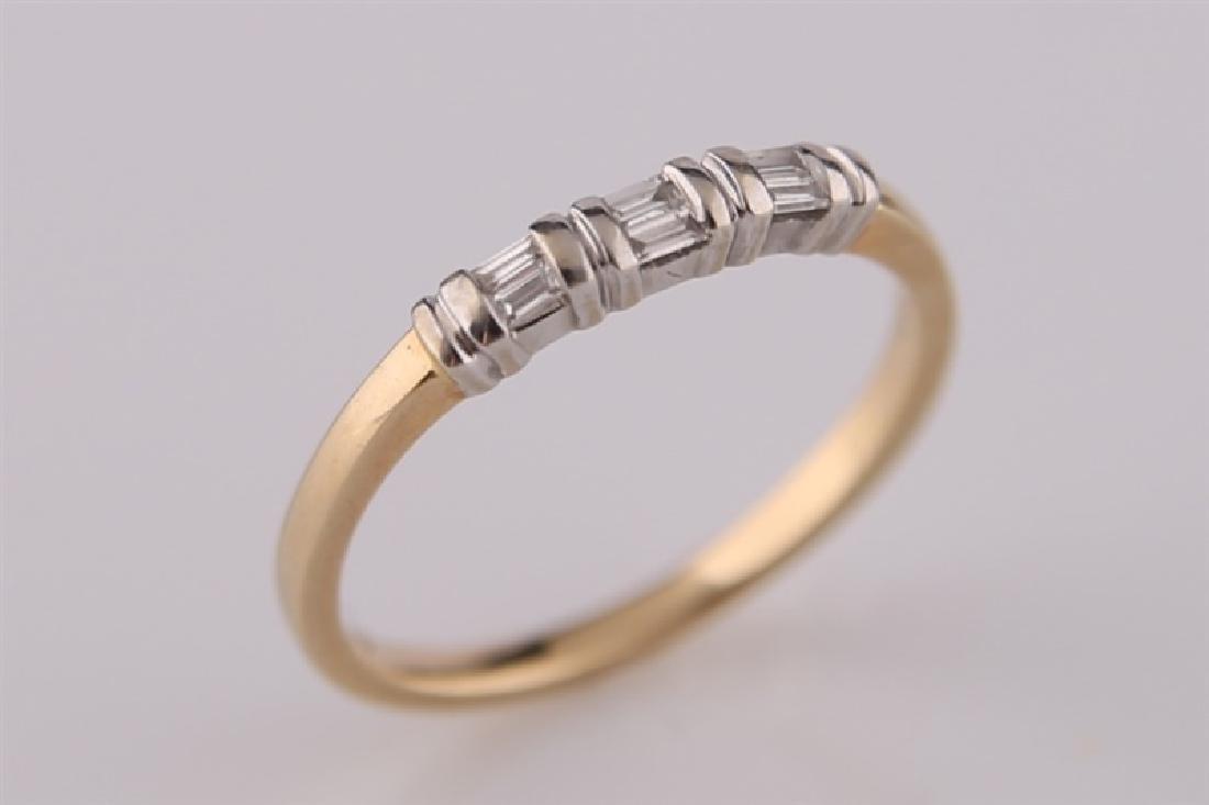 14kt Yellow Gold and Diamond Ring: 14kt two-tone yellow gold band ring with six (6) baguette diamonds totaling approx. .1 cts t/w. Band marked "14K" with maker's marks. Size: 7. Weight: 2.1 g.