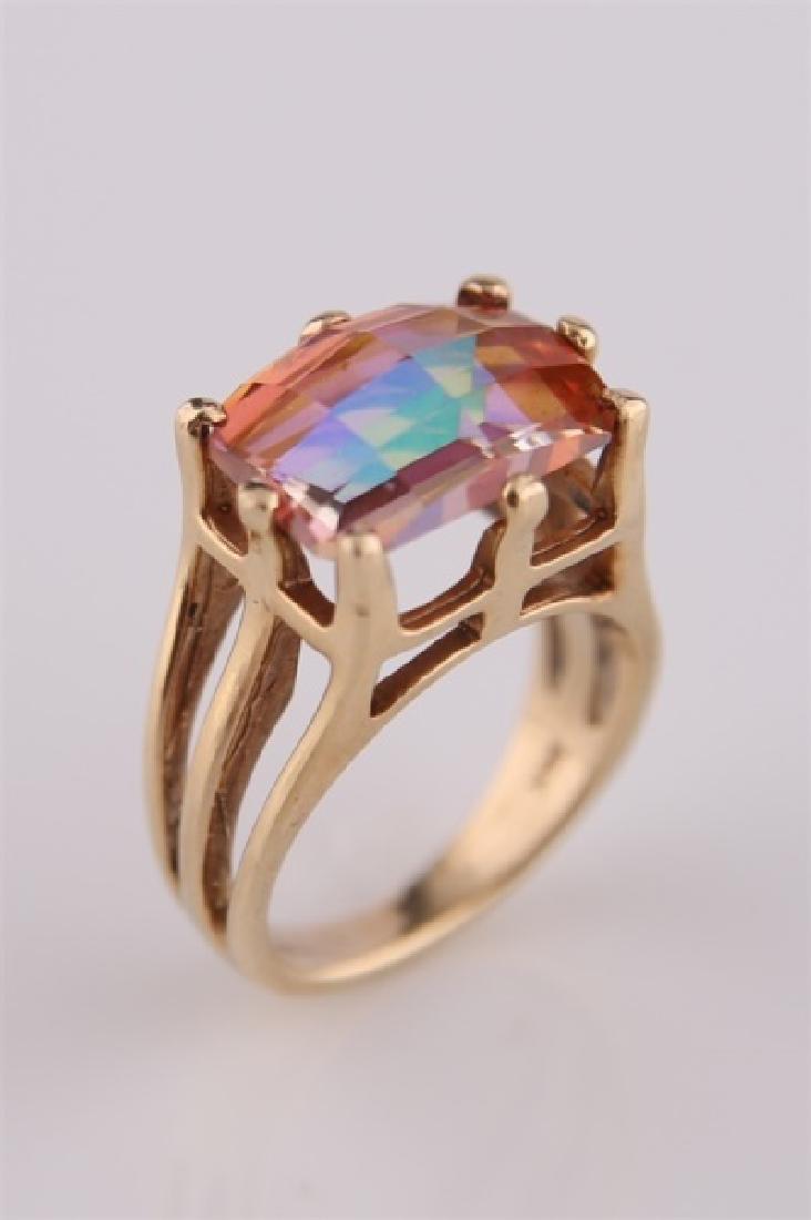 14kt Yellow Gold and Mystic Topaz Ring: 14k yellow gold ring with large mystic topaz stone. Stone cut into several facets. Interior of band marked "14K". Size: 7. Weight: 8 g.
