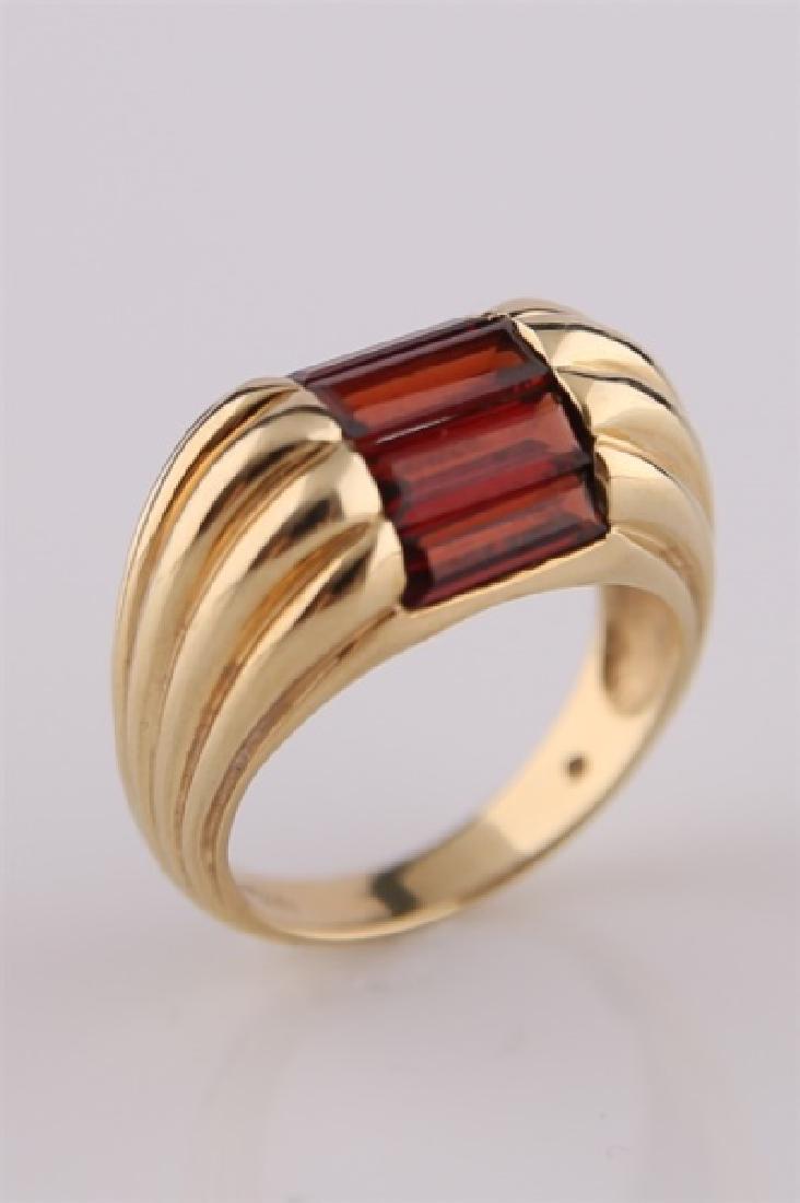 14kt Yellow Gold and Garnet Ring: 14kt yellow gold ring with rectangle-cut garnets. Ridged gold ring design with five garnets. Interior of band marked "14K CTD". Size: 6 1/2. Weight: 7 g.