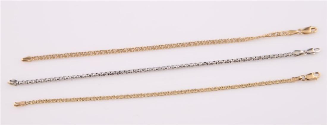 Lot of Three 14kt Gold Bracelets: Lot of three 14kt gold bracelets. One bracelet 14kt yellow gold with links, clasp marked "14k" with maker's marks, length: 6 3/4", weight: 3.1 g. One bracelet 14kt white gold with chain, clasp marked 