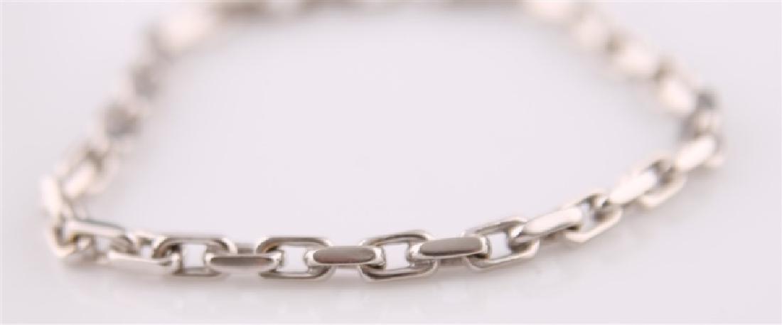14kt White Gold Anchor Link Chain Bracelet: 14kt white gold anchor chain link bracelet. Marked 14K on the inner lip of clasp. Length: 7", Weight: 11g.