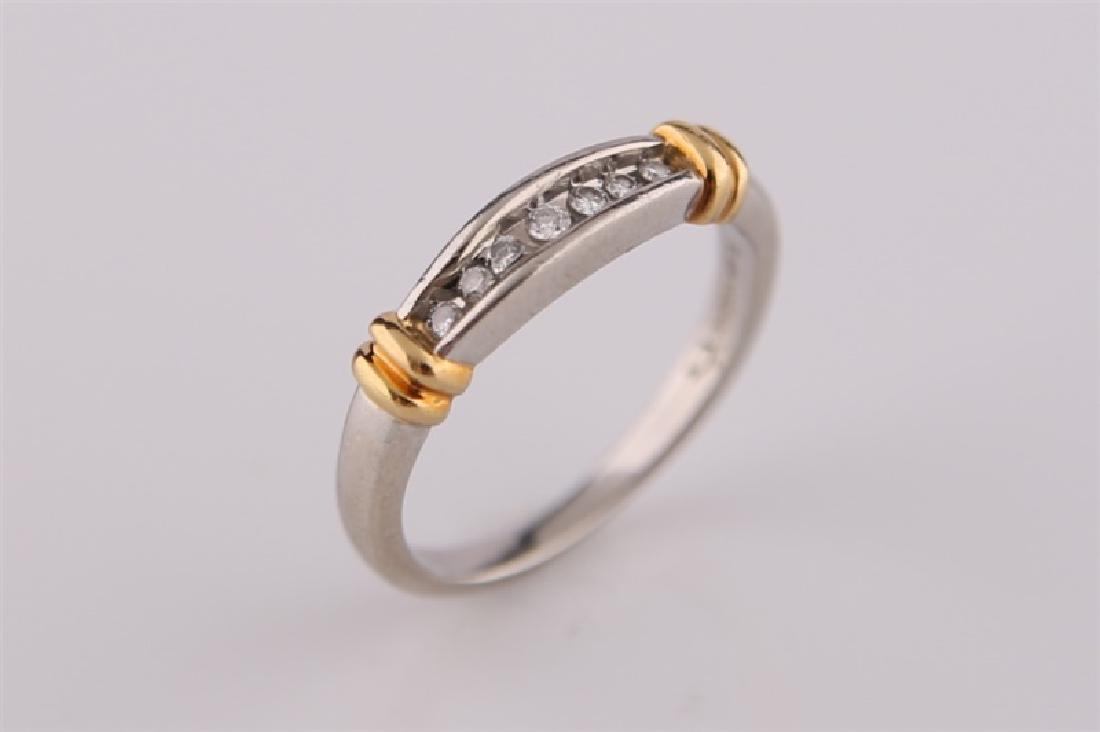 Platinum and 18kt Gold Ring: 18kt yellow gold and platinum ring. Seven diamonds totaling approx .09 cts. Interior of band marked with maker's marks. Size: 6 1/2. Weight: 4.5 g.