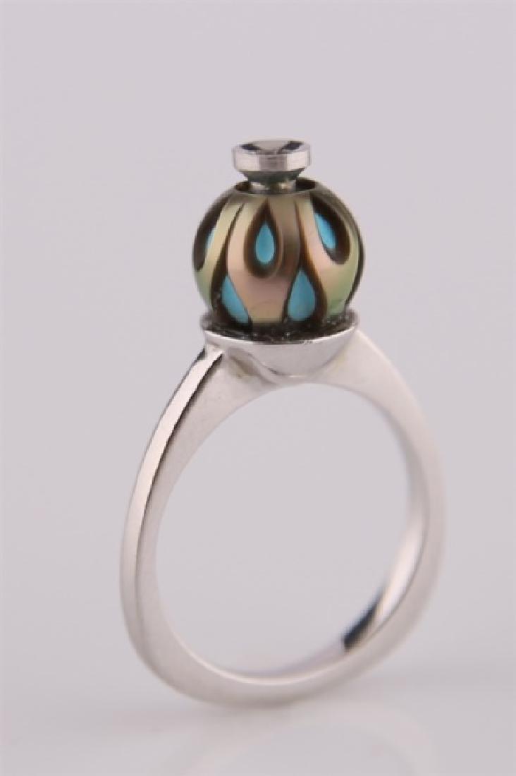 14kt White Gold Carved Pearl Ring: 14kt white gold carved pearl and enamel ring. One (1) diamond totaling approx. .08 cts. Band marked "14k". Size: 6 1/2. Weight: 4.3 g.