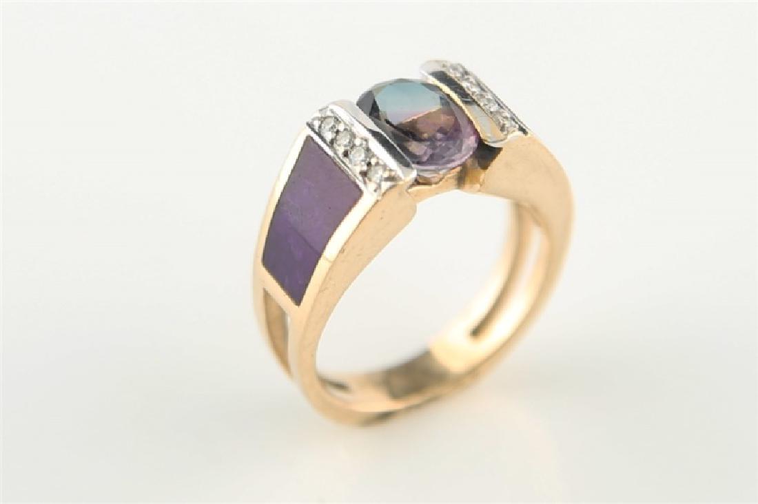 14kt Yellow Gold, Diamond, Sugilite, Iolite Ring: 14kt yellow gold ring with inlaid purple Sugilite, iolite, and diamond. Iolite is oval shaped, approx. 1.5cts, 9mm x 6mm x 4.5mm. There are eight diamonds, round brilliant cut, approx. .12 cts total w