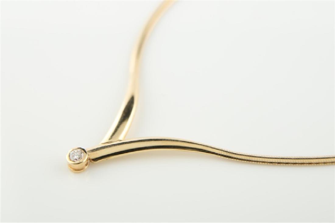 14kt Yellow Gold Omega-style Diamond Necklace: 14kt yellow gold Omega-style necklace. V-shaped omega-style necklace with center diamond. Diamond is round brilliant cut, approx. .35 cts., with Clarity: VS-2, Color: J. Necklace marked "14K Italy". L