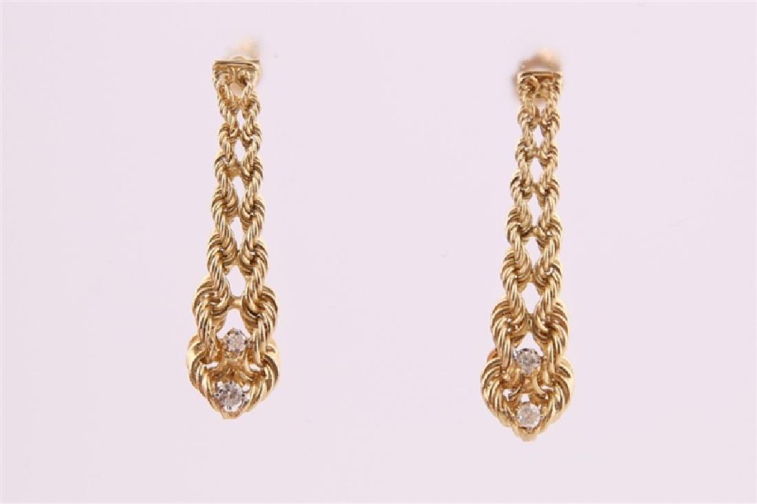 14kt Yellow Gold Chain Diamond Earrings: 14kt yellow gold articulated chain-like earrings with diamonds. Four diamonds total, approx. .03 ct. Marked "14K". Length: 1 1/2". Weight: 3.6 g.