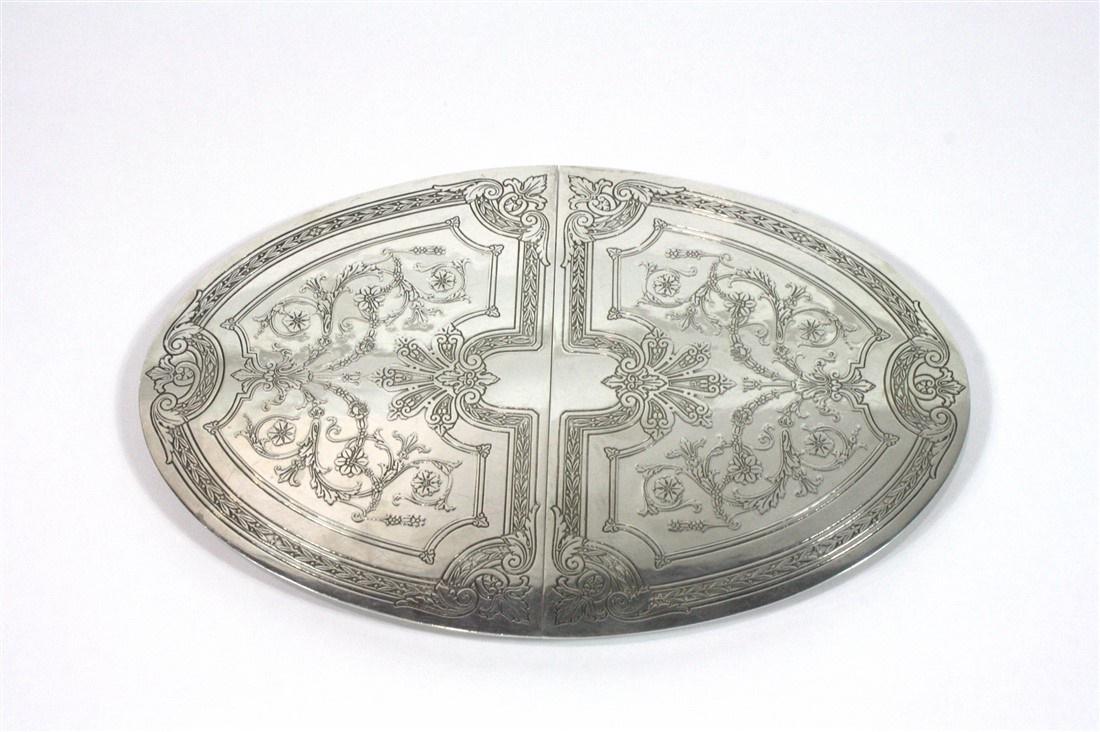 Tiffany and Co., Sterling Silver Expanding Trivet: Tiffany & Co. (American, est. 1837). Sterling silver. c. 1915-16. Pattern # 18915A. Order # 17439. Height: 1/2", Length: 13 1/8", Depth: 8 3/4", Extends to: 15". Weight: 27.745 ozt. Sterling silver ex