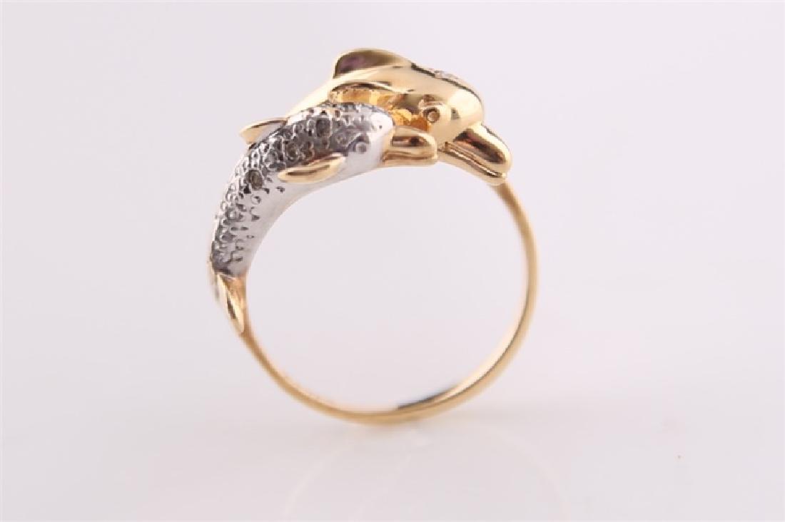 14kt Yellow and White Gold Dolphin Ring: 14kt yellow and white gold dolphin ring. Small single cut diamonds to dolphin. Interior of band marked "C.J.C. 14K". Size: 7 1/4. Weight: 4 g.