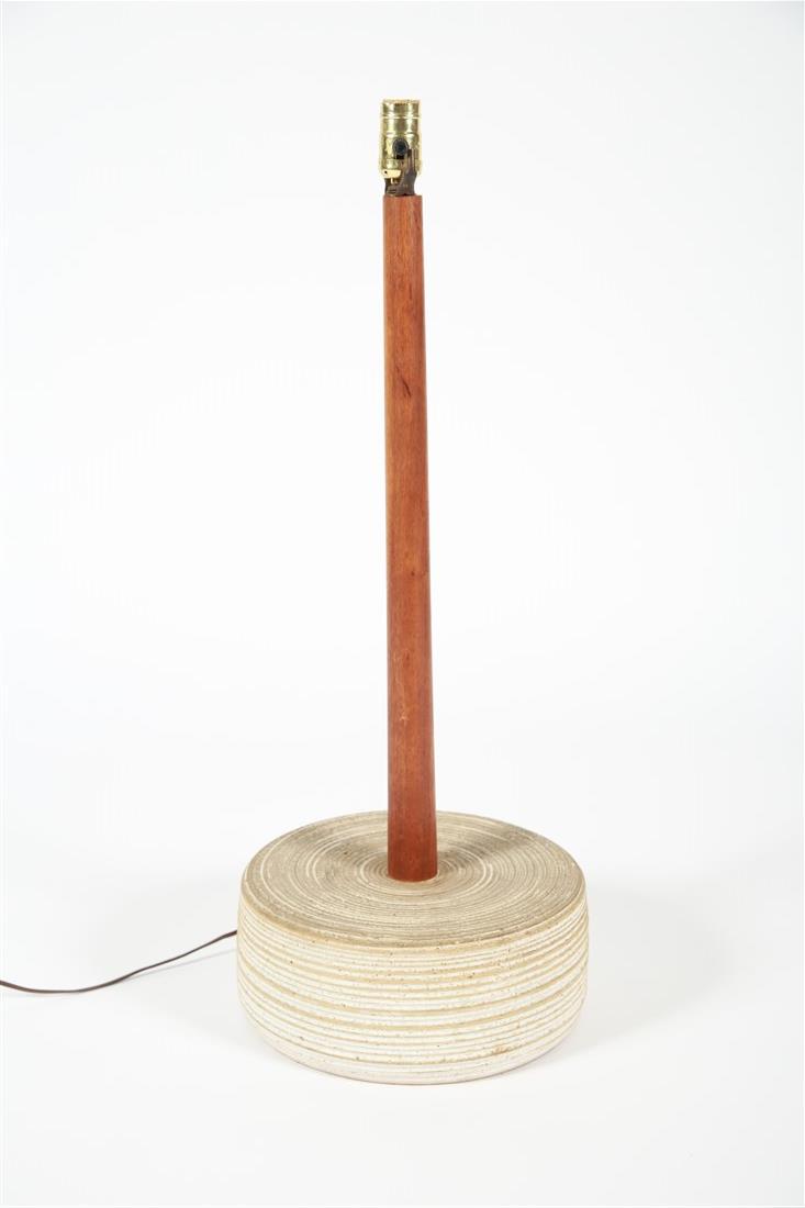 Walnut and Ceramic Base Lamp: Walnut, glazed ceramic. c. mid-20th century. Height: 30 1/2", Diameter: 11 3/4". Ceramic base lamp with walnut neck in the style of Gordon and Jane Martz. Felted bottom. Appears unmarked. Lamp is func