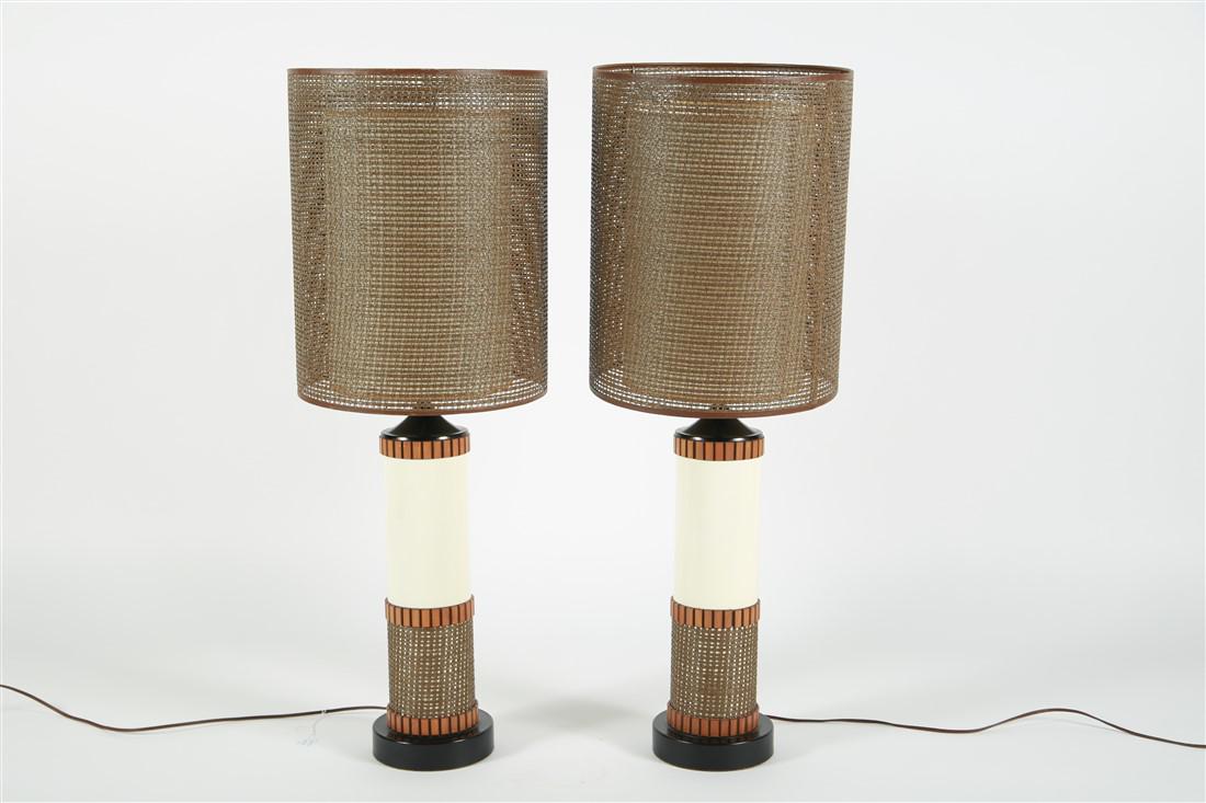 Pair of Cane and Wood Detail Table Lamps: Metal, caning, wood. c. mid-20th century. Height (including harp): 33", Dia.: 6 1/2". Shade: Height: 16 1/2", Dia.: 13 1/4". Pair of mid-century table lamps with wood and cane detailing. Double shade 