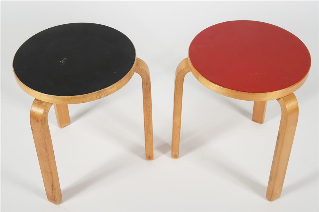 Pair of Alvar Aalto Style Stools: Style of Alvar Aalto (Finnish, 1898-1976). Wood. Red stool: Height: 17 5/8", Diameter: 14 1/2". Black stool: Height: 17 1/2", Diameter: 15". Pair of red and black stools in the style of Alvar Aalto. B