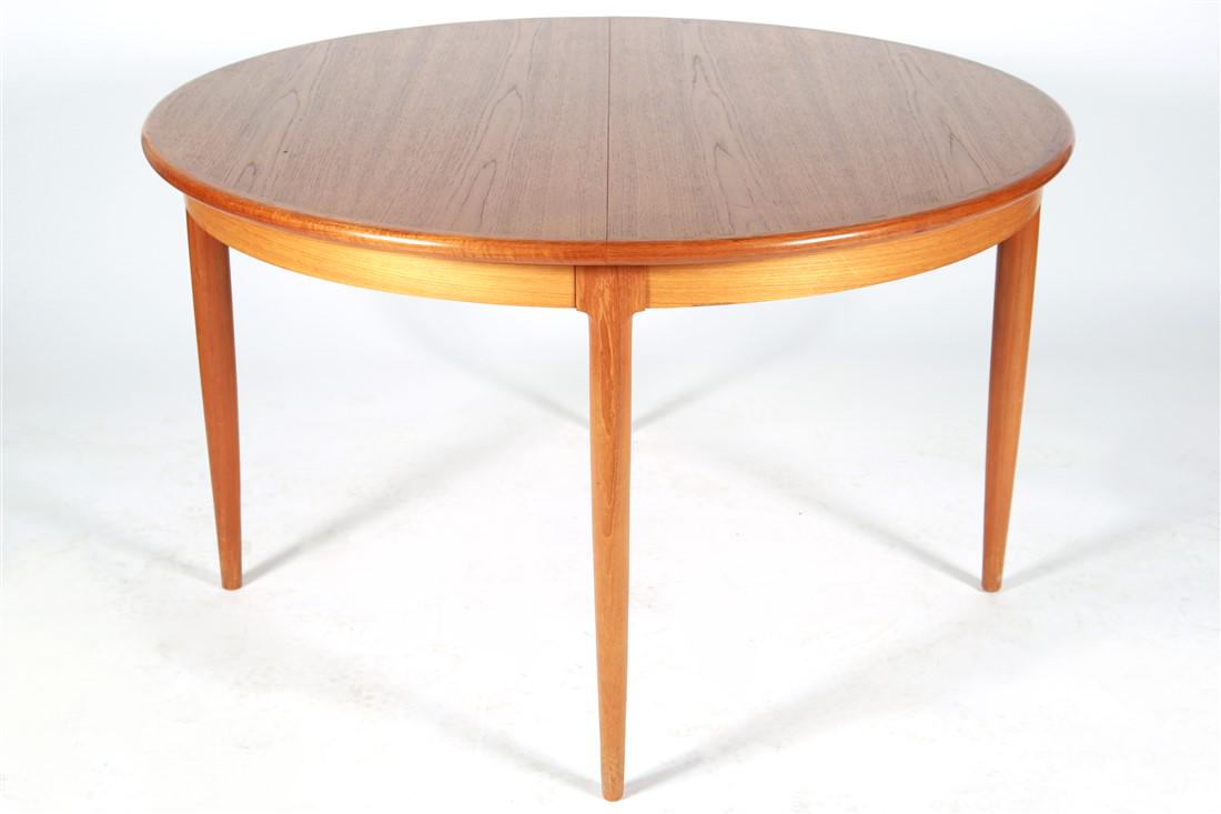 Niels O. Moller, Teak Dining Table: Niels Otto Moller (Danish, 1920-1982). Dining table. Teak. Production: 1970s. Distributed by J.L. Moller. Height: 28 1/2", DIA.: 48". Round teak dining table with two leaf inserts designed by Niels O.