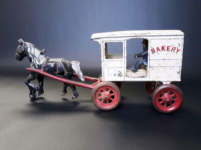 Cast Iron Bakery Cart: Kenton Hardware Co. Cast Iron. c. 1900. 5.75" x 12.75" x 3.75".