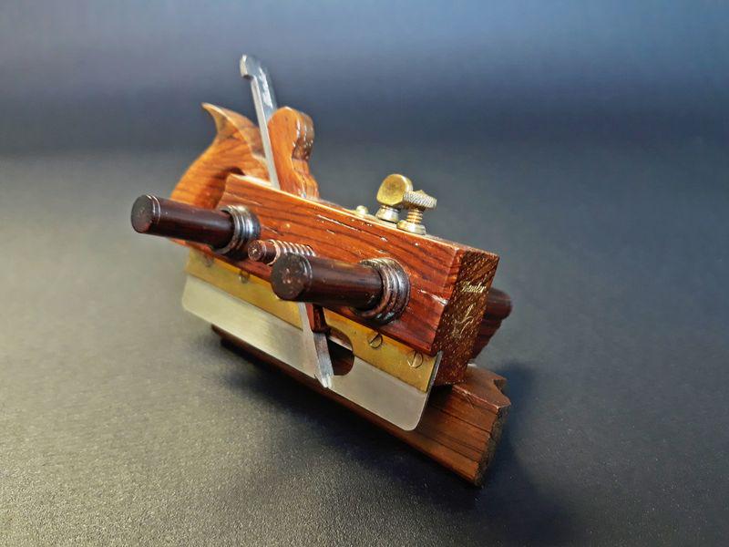 Miniature Sandusky Center Wheel Plow Plane: Paul Hamler. Wood, Steel, Brass. c. 1995-2005. 2.2" x 4.0" x 3.30".