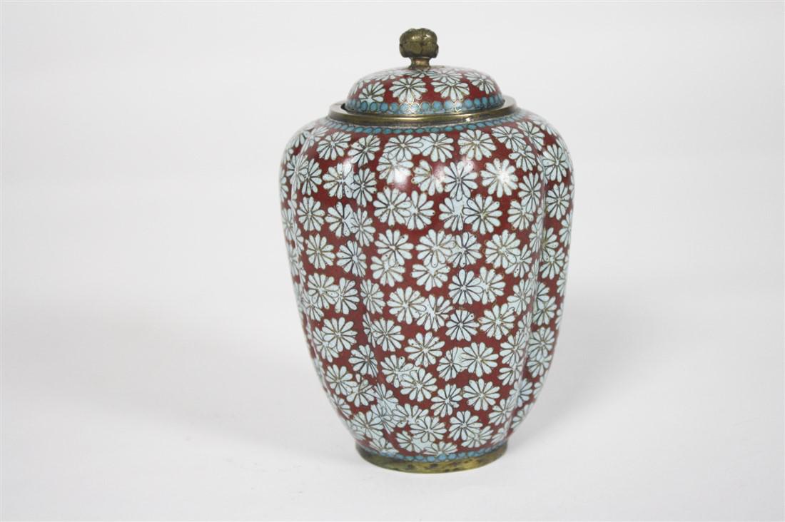 Cloisonne Urn with Lid: Cloisonne. Height: 4 1/2", Diameter: 3 1/4". Cloisonne urn with lid. Floral motif. Blue interior. Appears unmarked. Provenance: From the collection of Mr. Andrew Weertz, owner of Ports of Call, Ltd. i