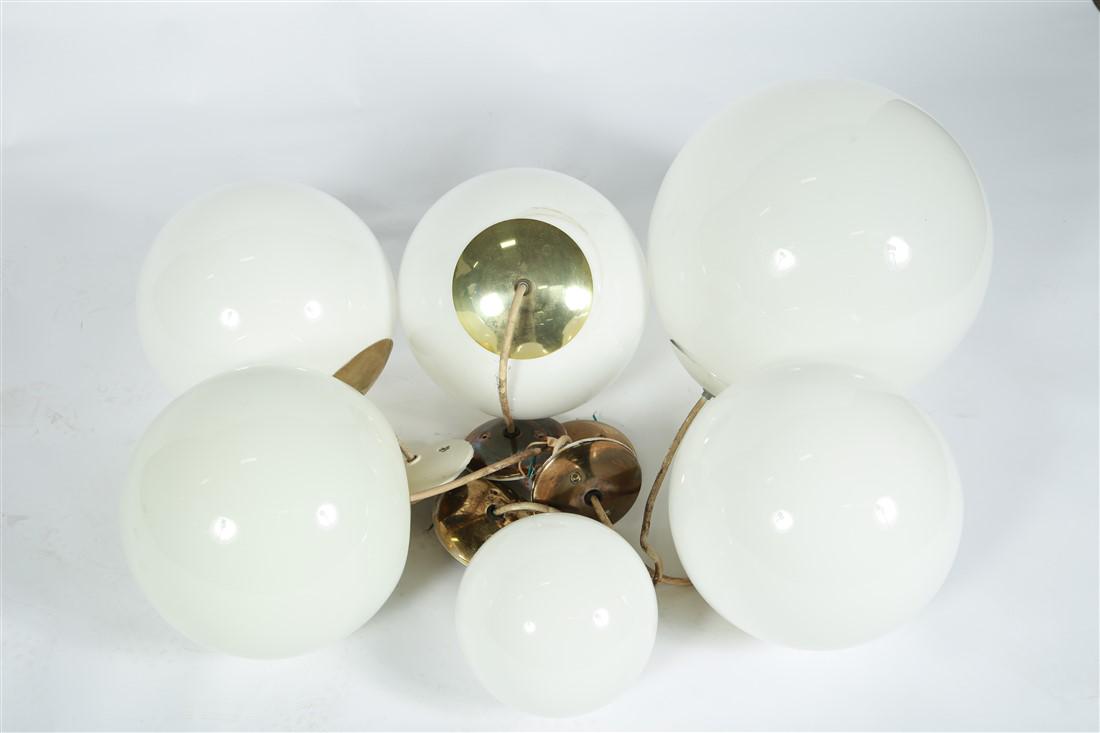 Mid-Century Glass Globe Pendant Lights: Glass, brass. c. mid-20th century. Small (1): Diameter: 8" approx., 9" from ceiling mount. Medium (4): Diameter: 12 1/2" approx., 12" from ceiling mount. Large (1): Diameter: 16", 16" from ceiling mou