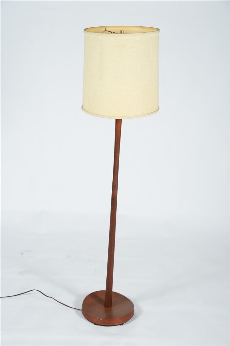 Mid-Century Walnut Floor Lamp: Floor lamp. Walnut. c. mid-20th century. Height: 54" (includes harp), Diameter: 10 1/2". Walnut floor lamp with linen shade. Walnut circular base with irregular shape. Appears unmarked/unlabeled. Lamp