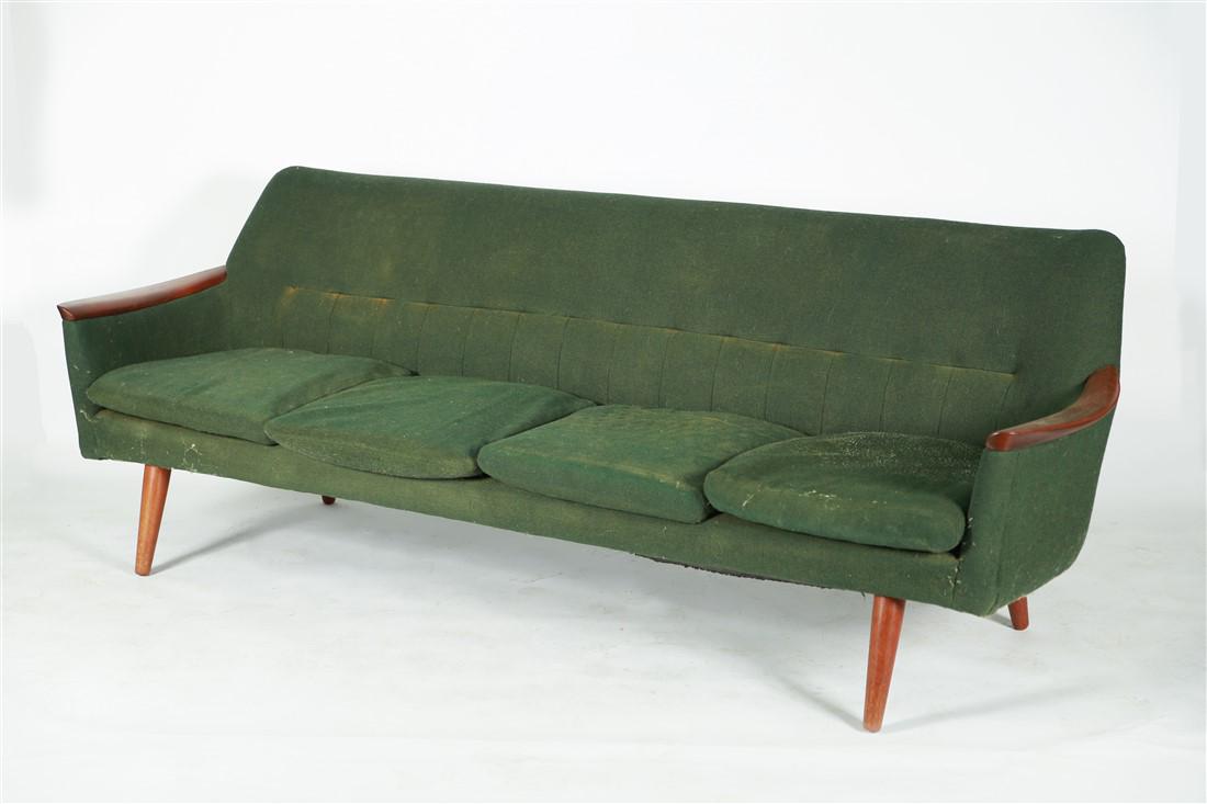 Green Upholstered Sofa with Walnut Frame: Sofa. Walnut and green upholstery. Unmarked. Height: 30 1/2", Length: 86 1/4", Depth: 28". Green upholstered sofa with walnut frame, four tapered legs, four cushions, and is unmarked.