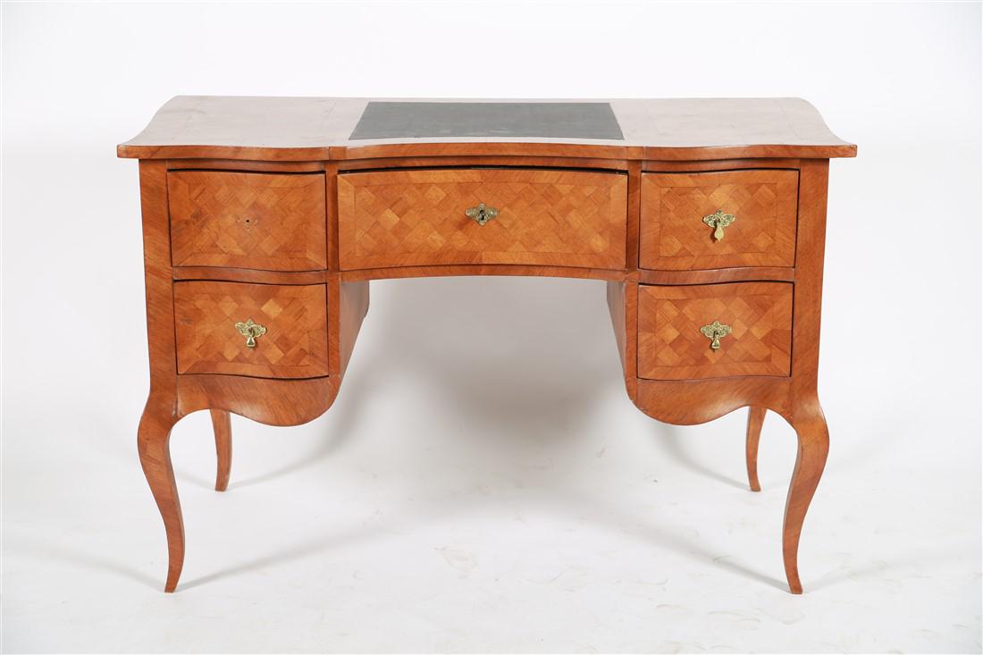 Biedermeier Inlaid Kneehole Desk: c. late 19th - early 20th century. Inlaid wood. Height: 31", Length: 46", Depth: 22 1/2". Checkered inlaid wood Biedermeier kneehole desk. Five drawers. Key to central drawer. Desk rests on four cabri